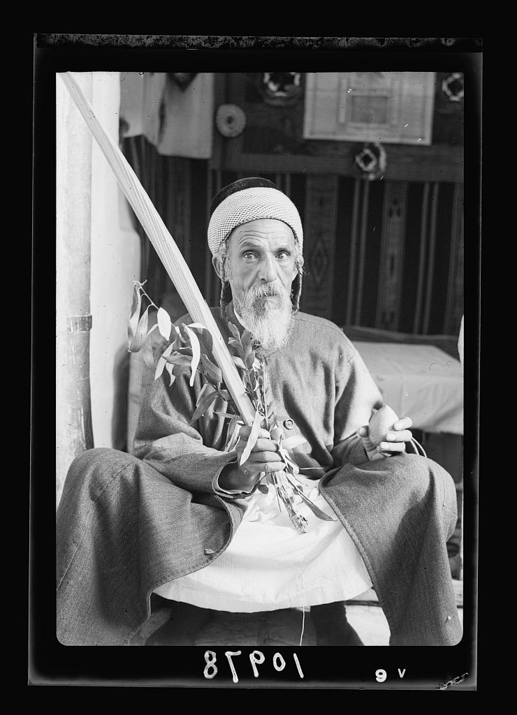 Yehia, a Yemenite Jew, holds a lulav and etrog during Sukkot. 1939